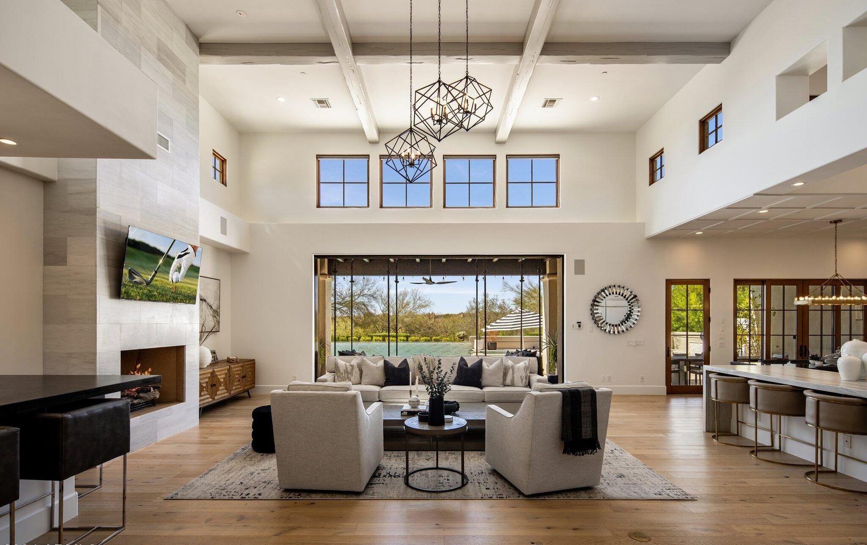 Great room with soaring ceilings, white oak floors and a furnished seating area