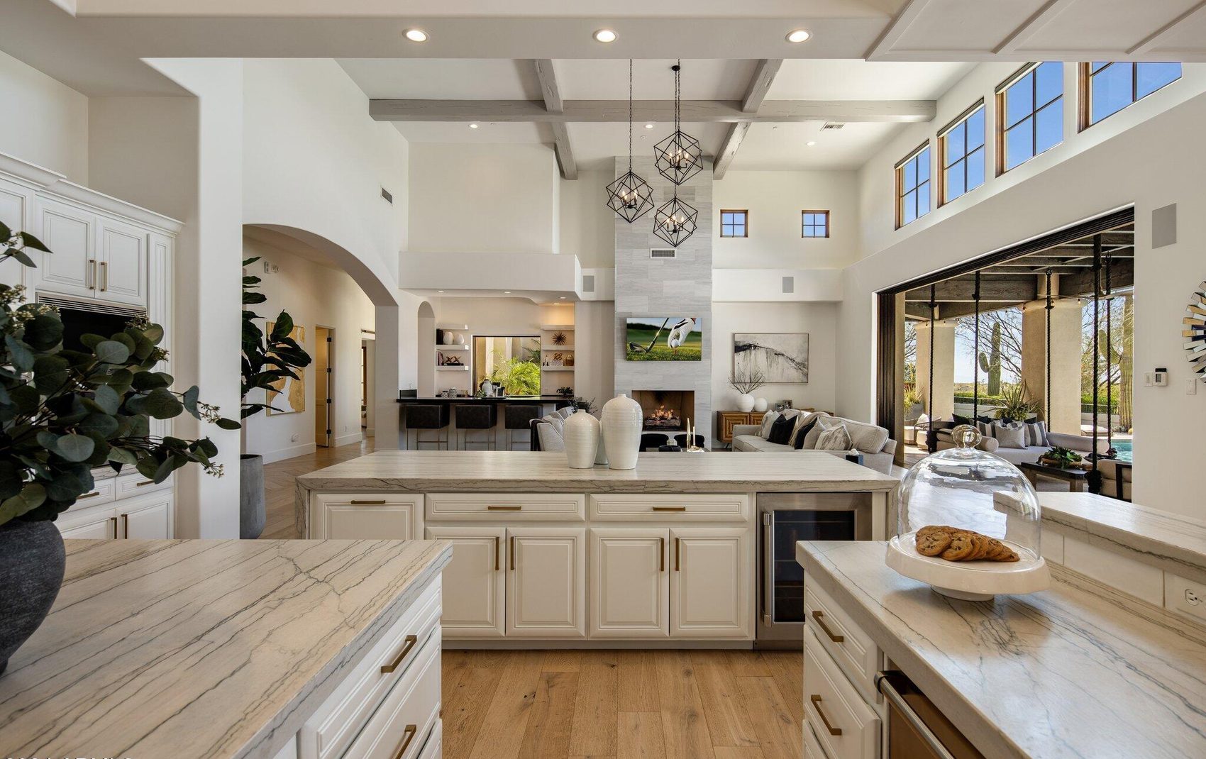 Chef's kitchen with waterfall island, gold pendants and white oak floors