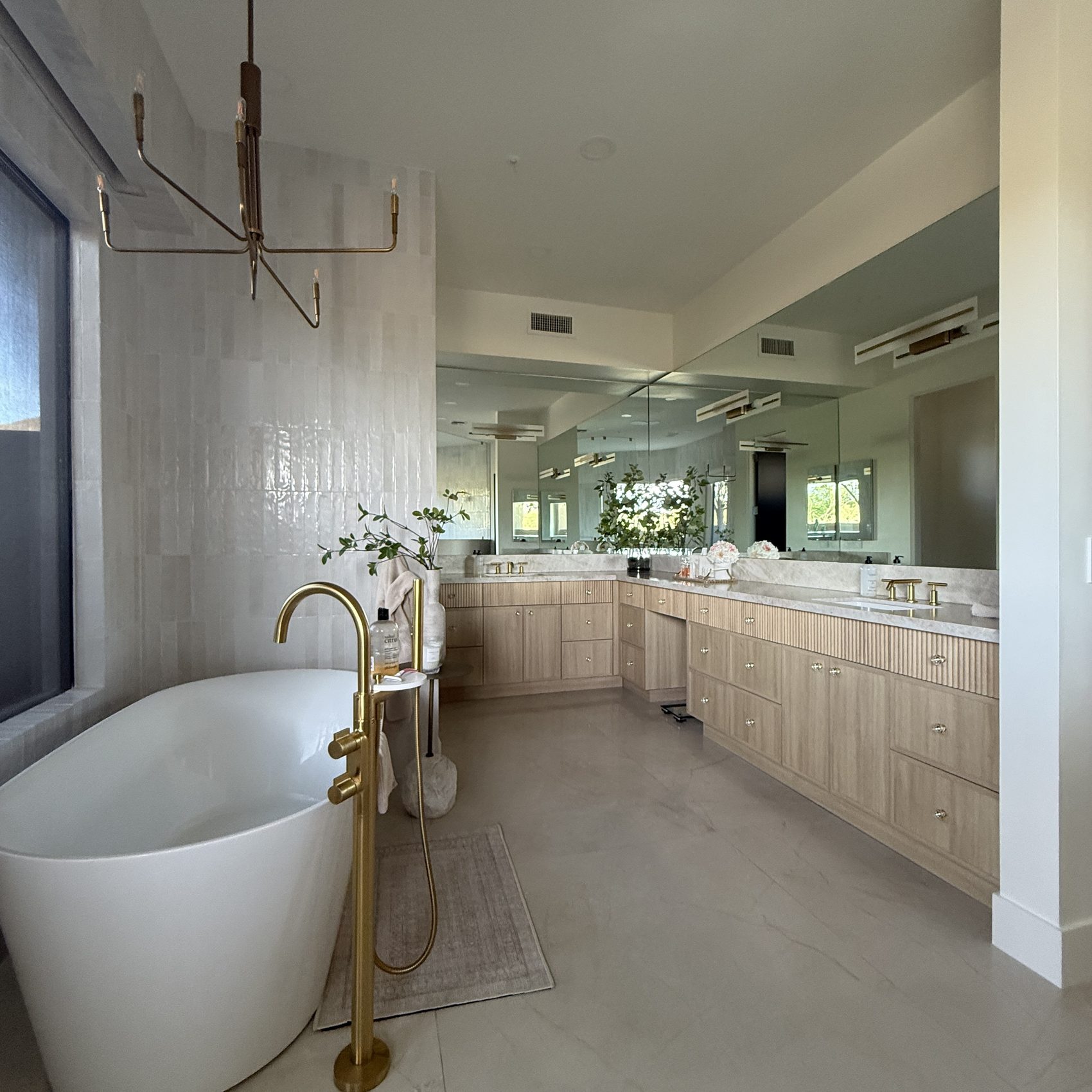 Primary bath with freestanding tub, brass tub filler and zellige tile