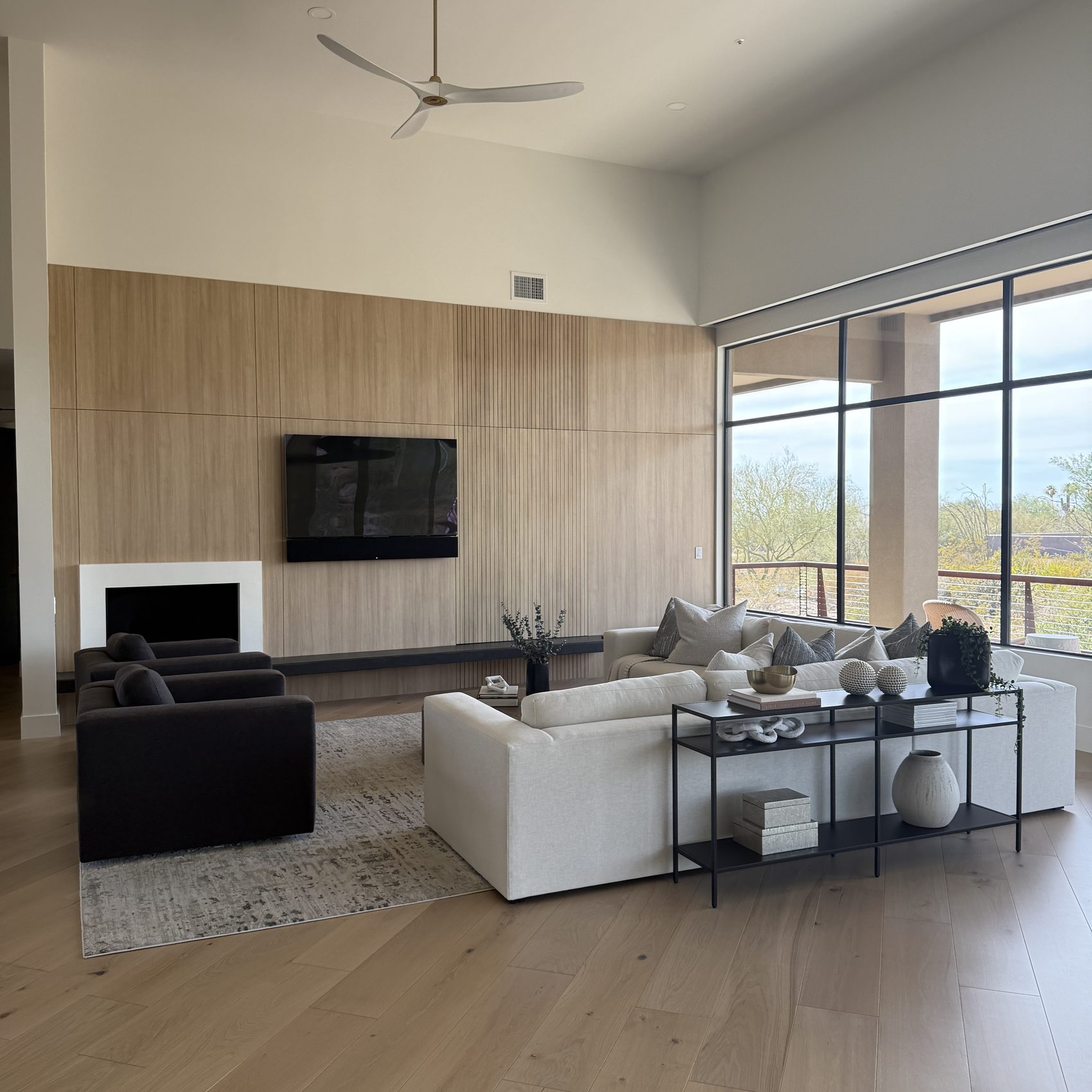 The same wall rebuilt — full-height rift white oak paneling with a linear fireplace