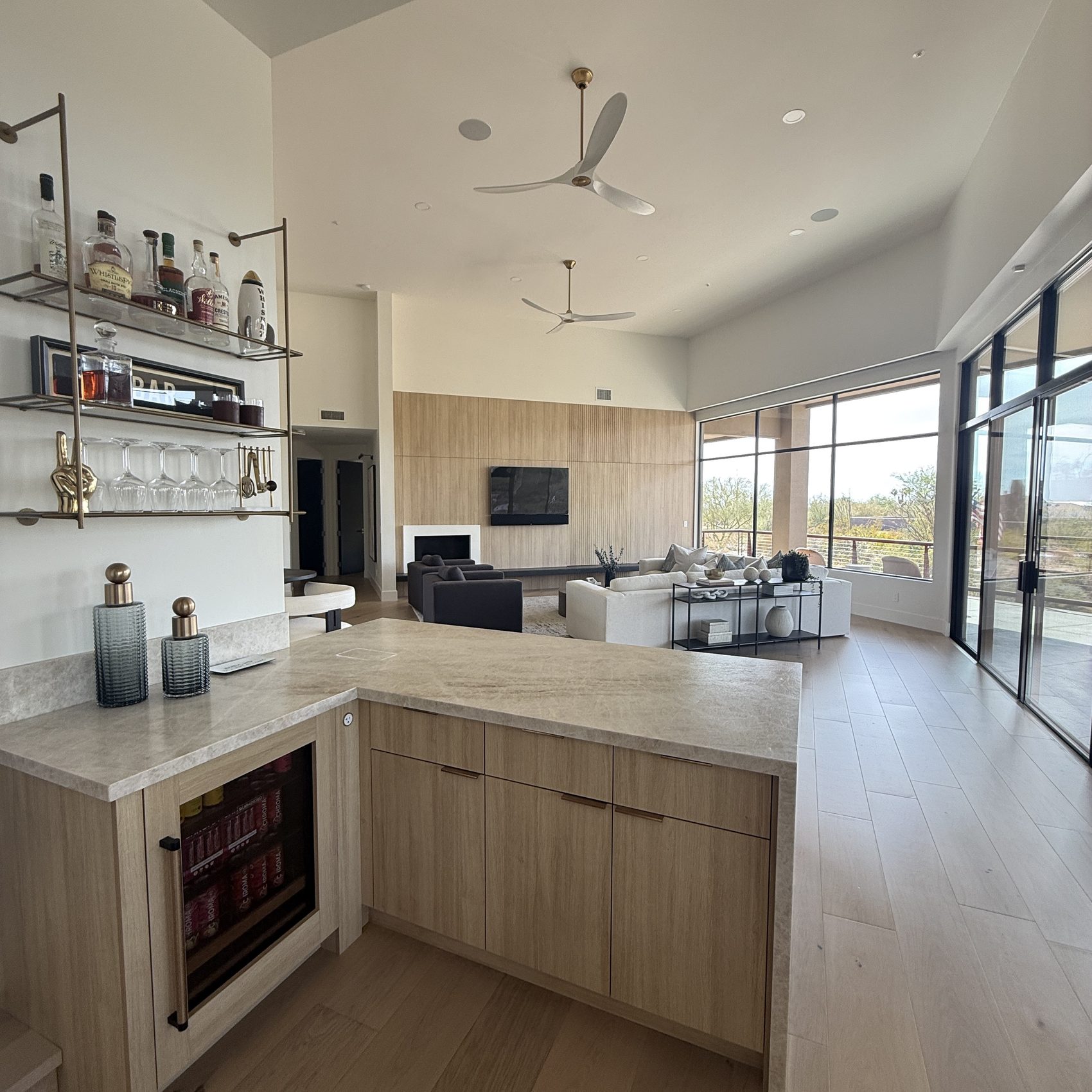 Kitchen and bar corner — rift white oak cabinetry, brass shelving and quartz counters